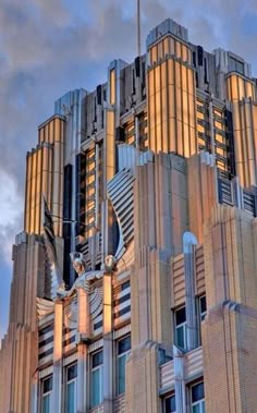 a very tall building with many windows on it's sides and a flag flying in the air