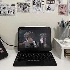 an open laptop computer sitting on top of a white desk