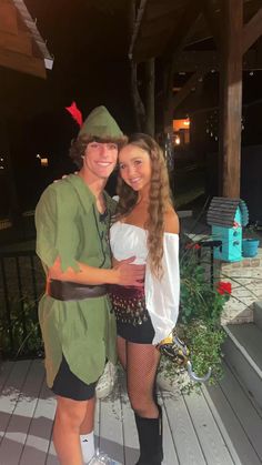 a man and woman dressed up as peter panton and robin from the little mermaid