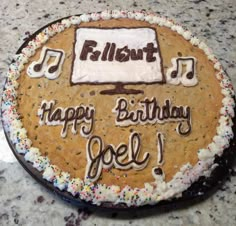 a birthday cake with the words happy birthday noel on it, and music notes written in frosting