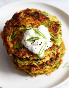 a plate with some food on top of it and garnished with sour cream