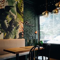 an image of a restaurant setting with tables and chairs in front of the window that reads muse eatery