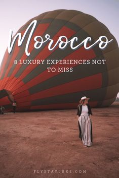 a woman standing in front of a hot air balloon with the words morocco and luxury experiences not to miss