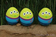 three easter eggs with faces painted on them