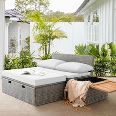 an outdoor day bed with storage underneath it