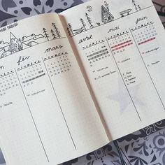 an open planner book sitting on top of a table