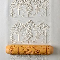 a rubber stamp with trees and snow on it