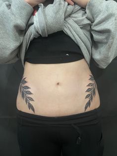 a woman's stomach with leaves on it and the bottom part of her body