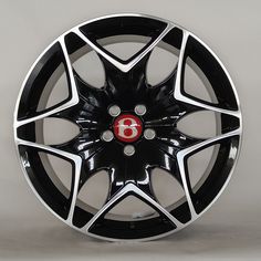 a black and white wheel with a red eight on the spokes is seen in this image