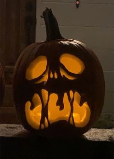 a carved pumpkin with an evil face on it