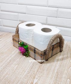 two rolls of toilet paper sitting in a basket