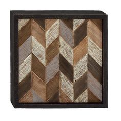 a wooden wall hanging with an abstract pattern in the center and two different colors on it