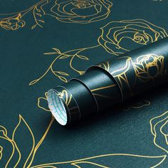 a roll of black paper with gold designs on it