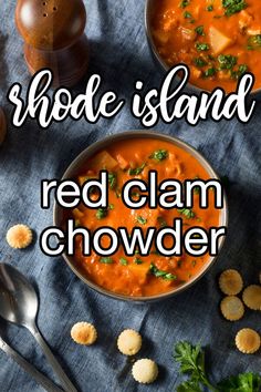 a bowl of red clam chowder with crackers on the side