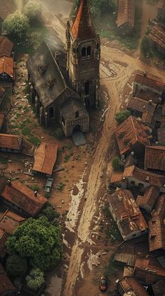 an aerial view of a village with a church and lots of trees in the background