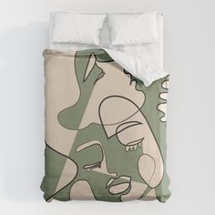 a bed with green and white artwork on it