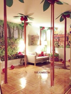 a living room filled with lots of furniture next to a wall covered in fake flowers