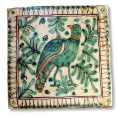 a decorative tile with a bird on it