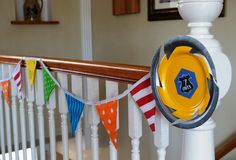 a yellow frisbee sitting on top of a white banister next to a flag