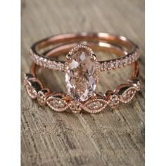 two rose gold wedding rings with an oval morganite