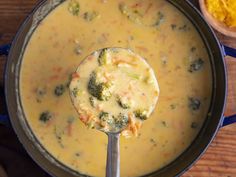 a ladle full of broccoli and cheese soup