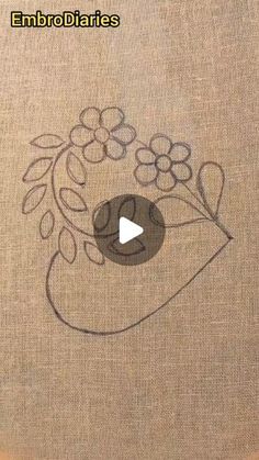 embroidery on fabric with an image of flowers and leaves in the center that says embrodilaries