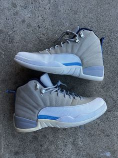 Elevate your sneaker game with these Nike Air Jordan 12 Retro University Blue Wolf Grey sneakers. The mid-top style and standard shoe width make these shoes perfect for any athletic activity, especially basketball. The nubuck upper material and Air Jordan product line ensure top-notch performance and style, while the retro theme and 2016 release year add a touch of nostalgia to your wardrobe. These sneakers are size 12 for men and feature a sleek gray and blue color scheme with the iconic Jordan silhouette. Don't miss out on this must-have addition to your collection. Blue And Gray Jordans, Jordan Mid-top Fade-resistant Streetwear Shoes, Mid-top Fade-resistant Basketball Sneakers, Mid-top Fade-resistant Sneakers For Basketball, Casual Blue High-top Basketball Sneakers, Casual Blue High-top Sneakers For Basketball, Sporty High-top Basketball Sneakers Fade-resistant, Fade-resistant Mid-top Basketball Shoes, Sporty High-top Sneakers For Basketball