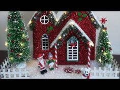 a red house with christmas decorations and trees