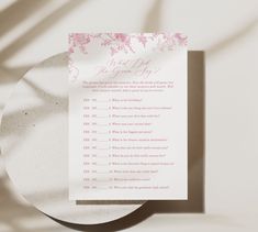 a pink and white wedding program on top of a plate with the word, what do you mean?