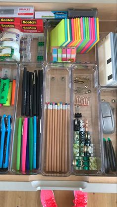 an organized drawer with lots of pens, pencils and other office supplies in it