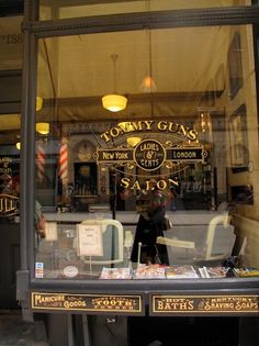 a store front window with the reflection of a man in it's glass display