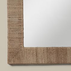 a mirror that is made out of wood and has a wooden frame on the wall