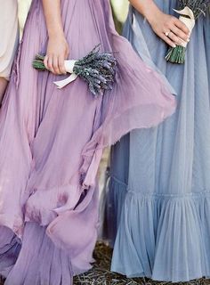 three women in dresses standing next to each other