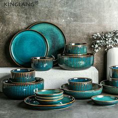 a table topped with blue dishes and plates