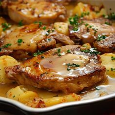 some meat and potatoes on a plate with gravy