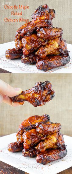 chicken wings are stacked on top of each other and being held up by someone's hand