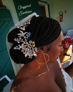 a woman with gold paint on her face and hair in a bridal gown is looking at the camera