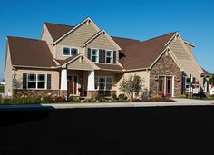 a large house with lots of windows on the front and side of it's roof