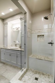 a large bathroom with two sinks and a walk in shower