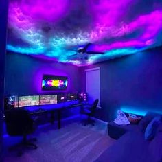 a living room with purple and blue lights on the ceiling, video game controllers in front of them