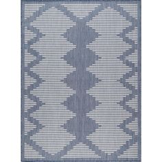 a blue and white rug with an abstract design on the bottom, in front of a white background