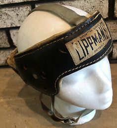 an old leather helmet with the name lippmman on it's visor