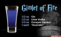 a glass filled with blue liquid next to a sign that says, gimet of fire