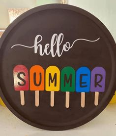 a sign that says hello summer with popsicles on it in front of some bananas