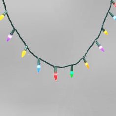 multi - colored christmas lights are hanging on a string