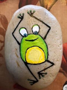 a painted rock with a frog on it