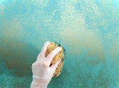 a person in white gloves is holding up a piece of food on a blue surface