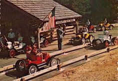 an old time car show with people riding in cars and other vehicles on the road