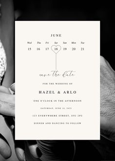 two people holding each other's hands in front of a white card with the word save the date printed on it