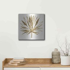 a white and gold wall hanging above a wooden table